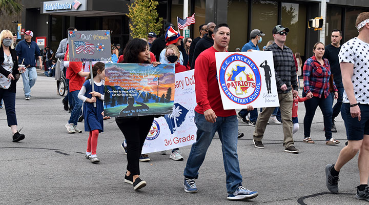 People marching in a veteran's day parade