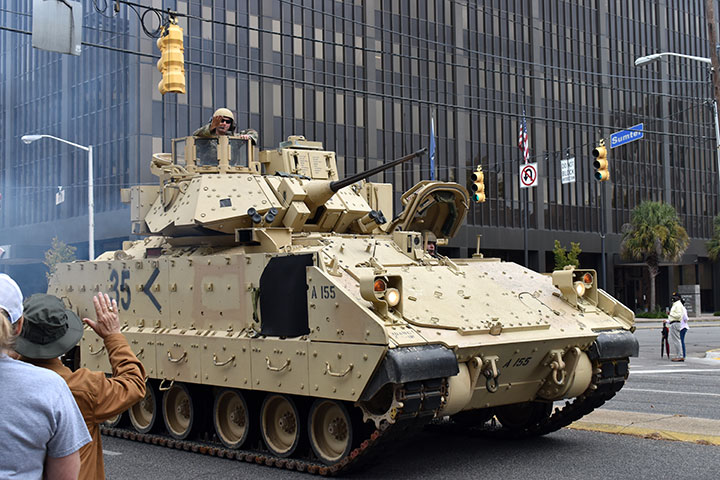 A man waves from an Army tank