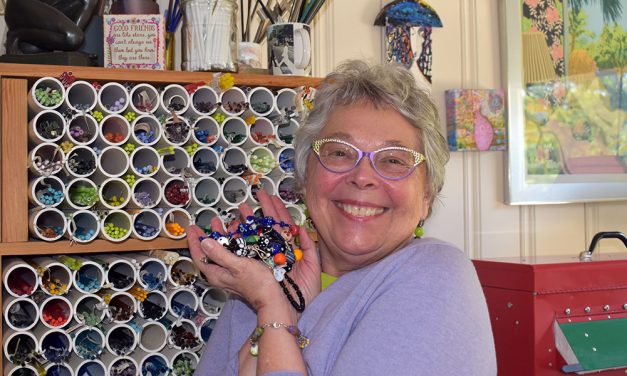 Glassblower turns over a new bead