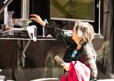 A person buys lunch from a food truck during court recess.