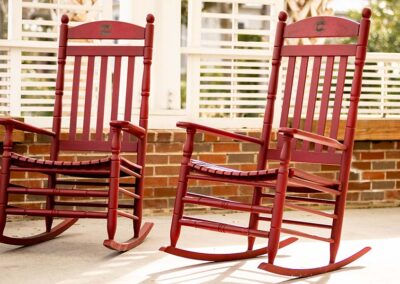 Red rocking chairs outside of the wildlife center.