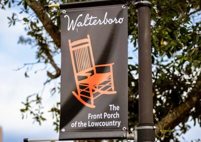 A sign featuring the red rocking chair and slogan "The Front Porch of the Lowcountry".