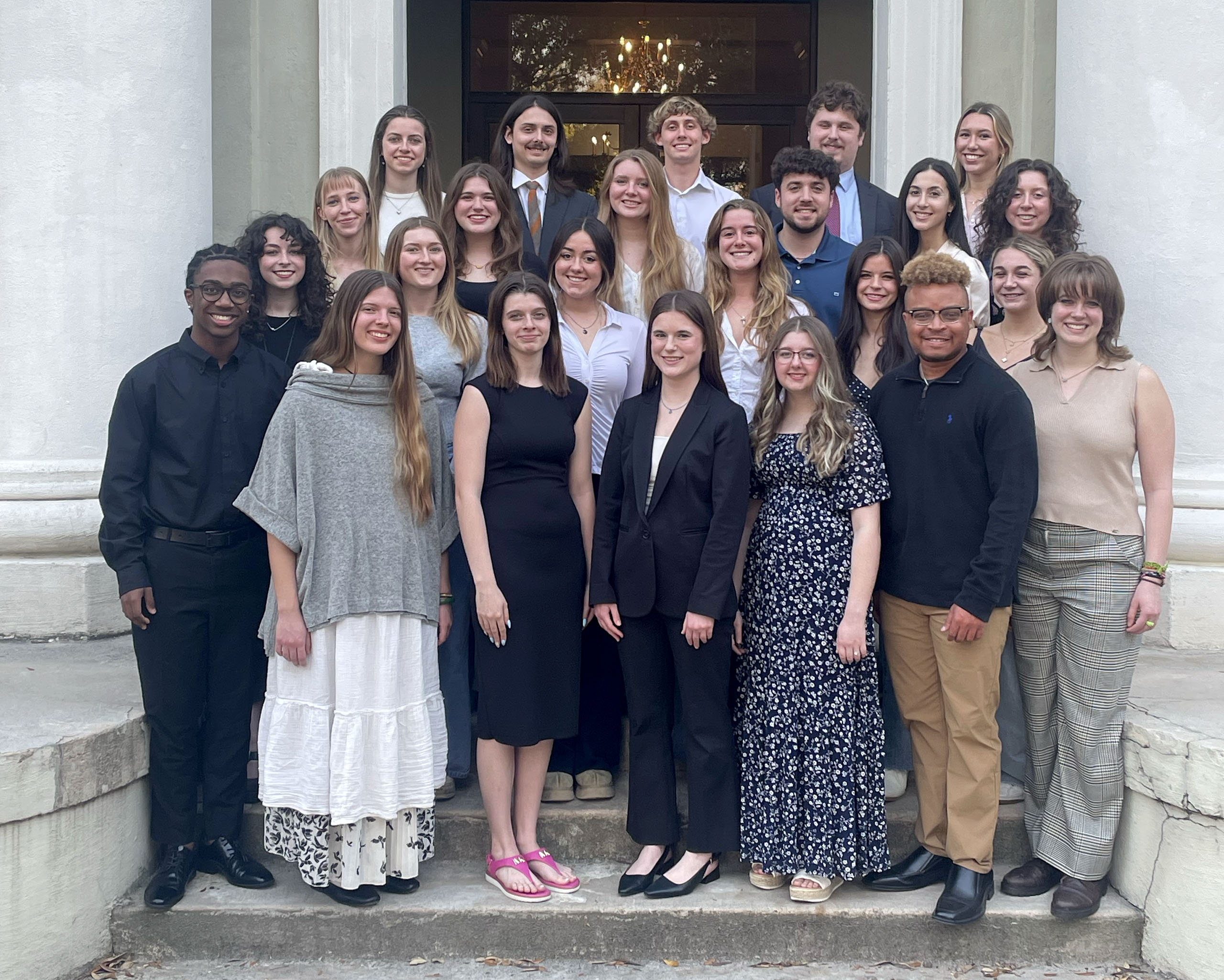 The Carolina Reporter staff poses for a photo on the steps of a USC building.
